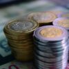stacks of silver and gold coins in close up photography