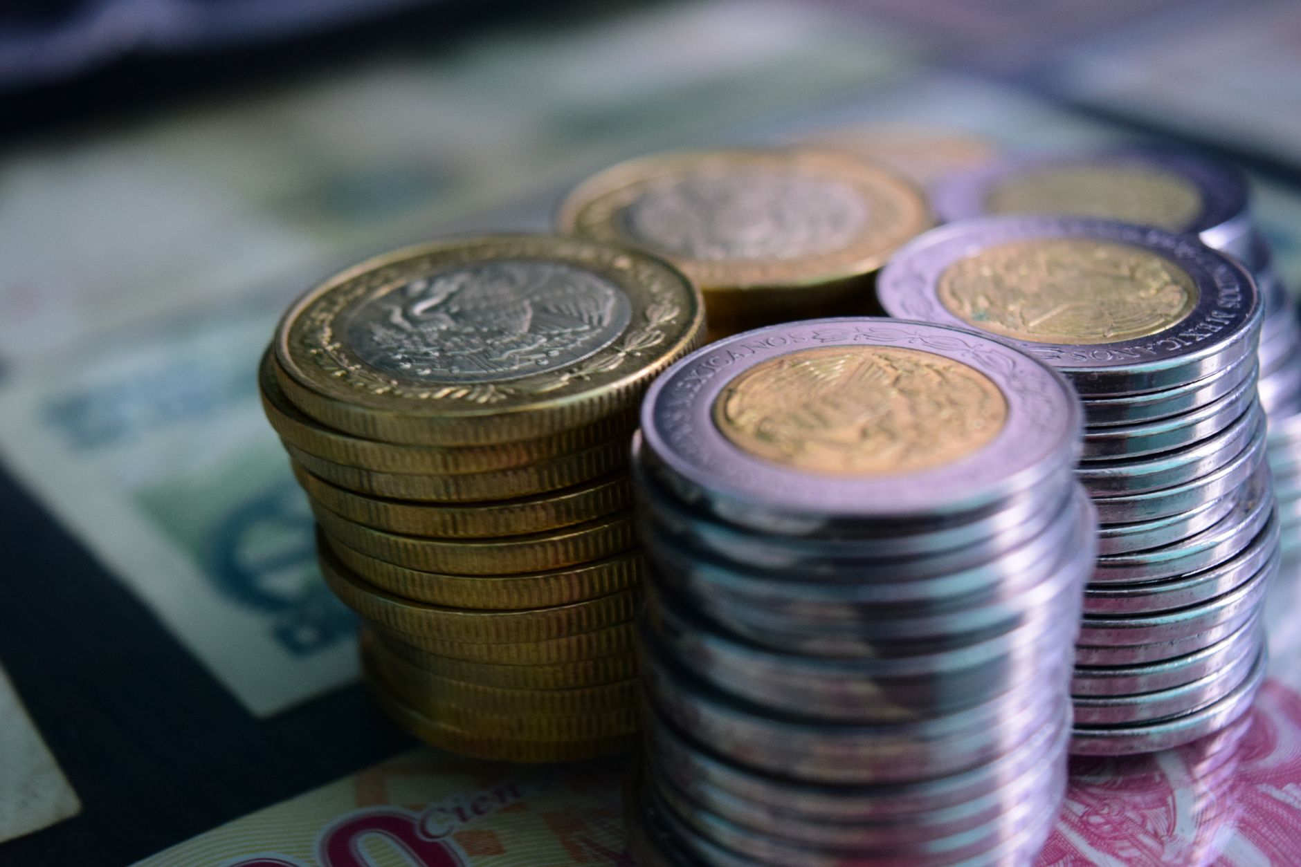 stacks of silver and gold coins in close up photography